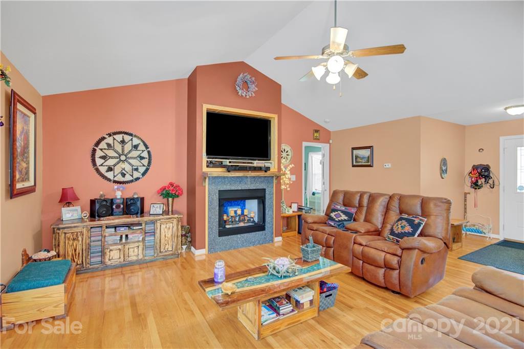 3520 Mack Ballard Road Maiden, NC 28650 - Photo 18 of 25 a living room with furniture a flat screen tv and a fireplace