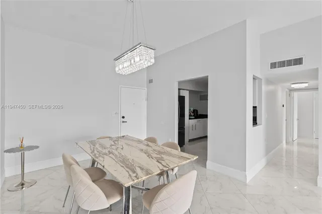 a kitchen with stainless steel appliances granite countertop a stove a refrigerator and a microwave