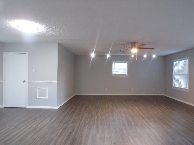 Undisclosed Address Marion, AR 72364 - Photo 3 of 12 an empty room with wooden floor and windows