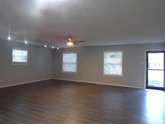 Undisclosed Address Marion, AR 72364 - Photo 5 of 12 an empty room with wooden floor and windows