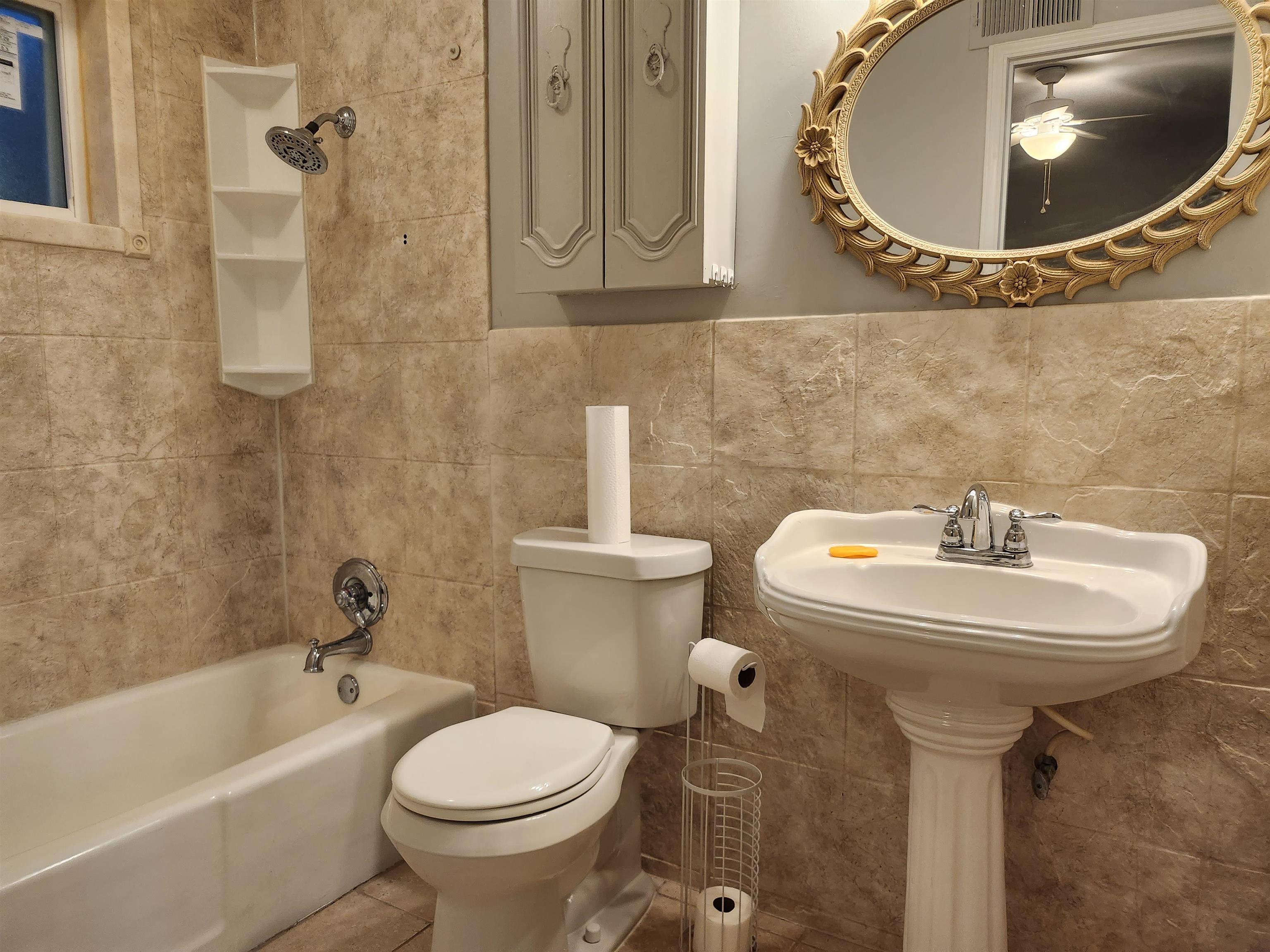 Undisclosed Address Marion, AR 72364 - Photo 6 of 12 a bathroom with a sink and mirror with toilet