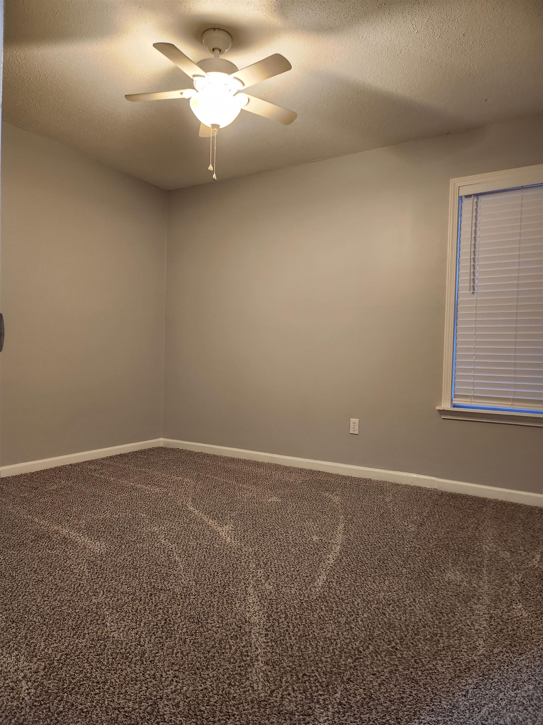 Undisclosed Address Marion, AR 72364 - Photo 7 of 12 a view of an empty room with a window