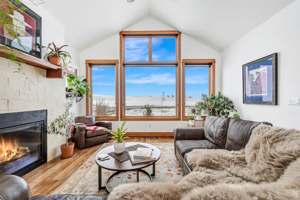 870 Dry Creek Road Hayden, CO 81639 - Photo 2 of 50 a living room with furniture a fireplace and a large window