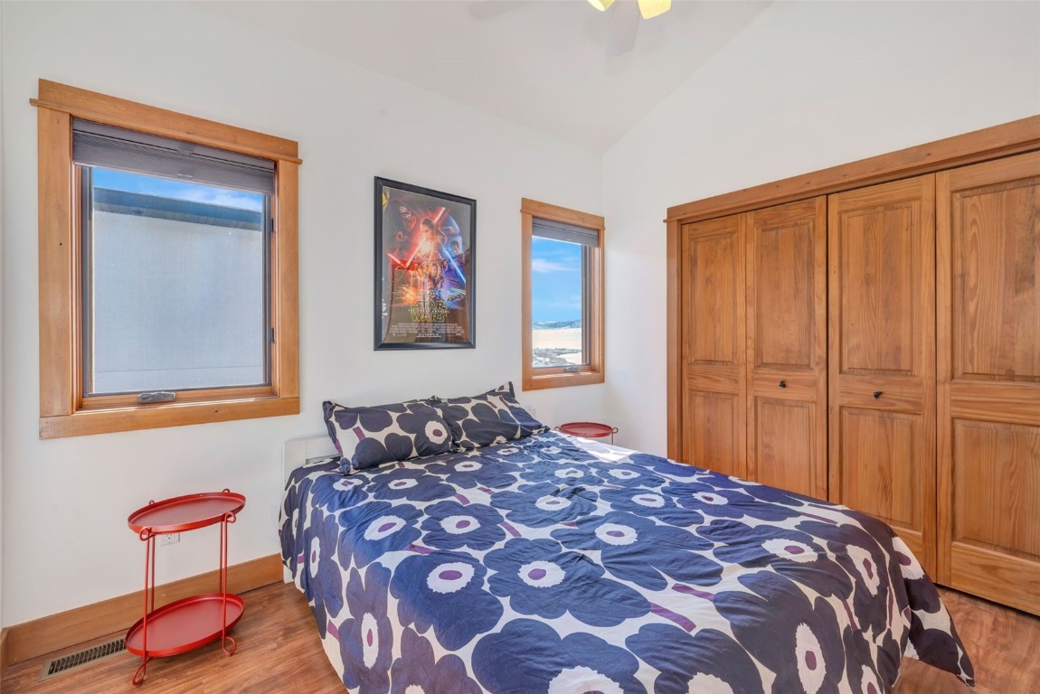 870 Dry Creek Road Hayden, CO 81639 - Photo 21 of 50 a bedroom with a bed and wooden floor