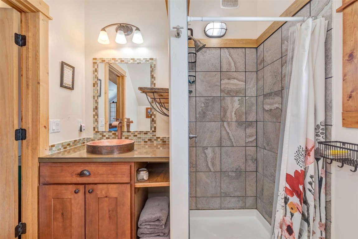 870 Dry Creek Road Hayden, CO 81639 - Photo 43 of 50 a bathroom with a sink vanity and a mirror