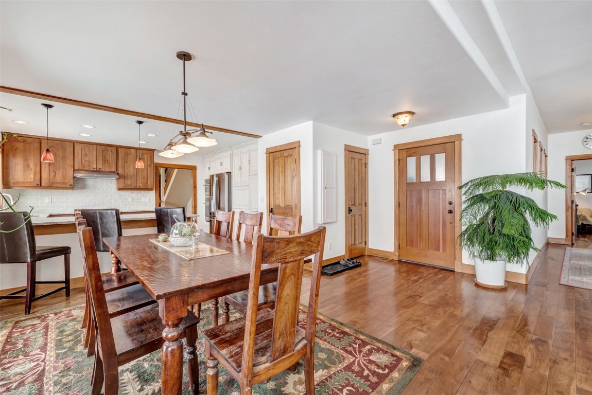 870 Dry Creek Road Hayden, CO 81639 - Photo 5 of 50 a view of a dining room and livingroom with furniture wooden floor a chandelier