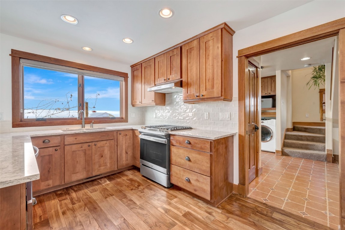 870 Dry Creek Road Hayden, CO 81639 - Photo 8 of 50 a kitchen with granite countertop cabinets stainless steel appliances and a counter space