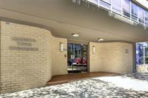 1800 Lavaca Street, Unit 107 Austin, TX 78701 - Photo 2 of 16 A secure brick entryway leads into this modern building under a protected overhead canopy.
