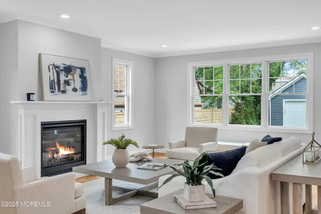 a living room with furniture a fireplace and a large window