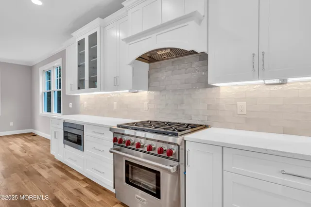 a kitchen with granite countertop a stove and a sink