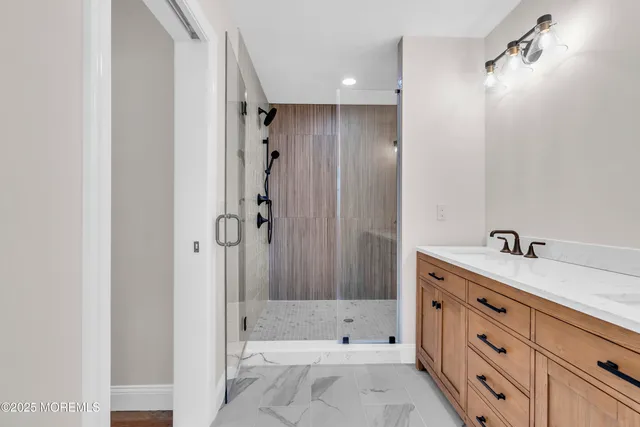 a bathroom with a granite countertop sink a toilet and shower