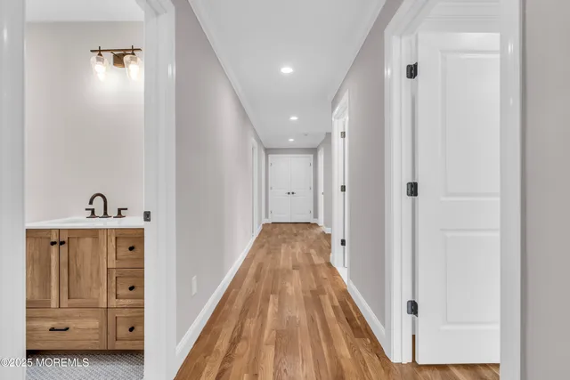 a view of a hallway with entryway wooden floor and front door