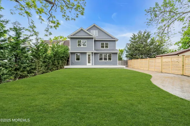 a front view of a house with a garden and yard