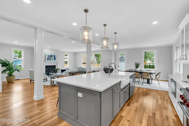 a large kitchen with kitchen island a island a stove a table and chairs in it