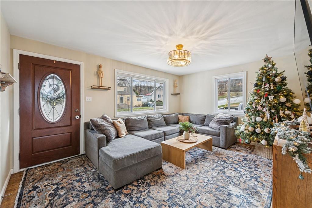 1000 Colfax Street Springdale, PA 15144 - Photo 2 of 25 a living room with furniture a clock and a window