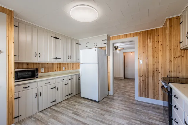 a kitchen with stainless steel appliances a refrigerator sink and cabinets
