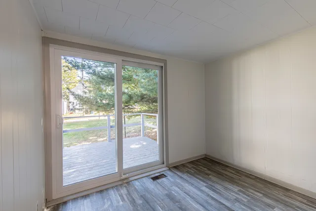 a view of an empty room and wooden floor