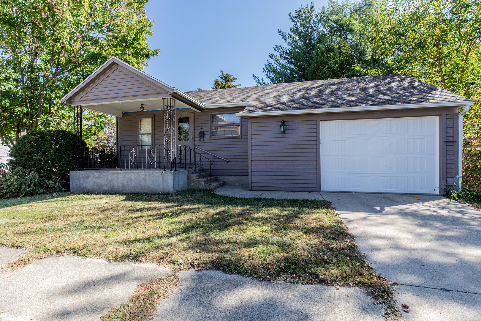 9 South Randolph Street Princeton, IL 61356 - Photo 2 of 26 a view of a house with a small yard plants and large tree