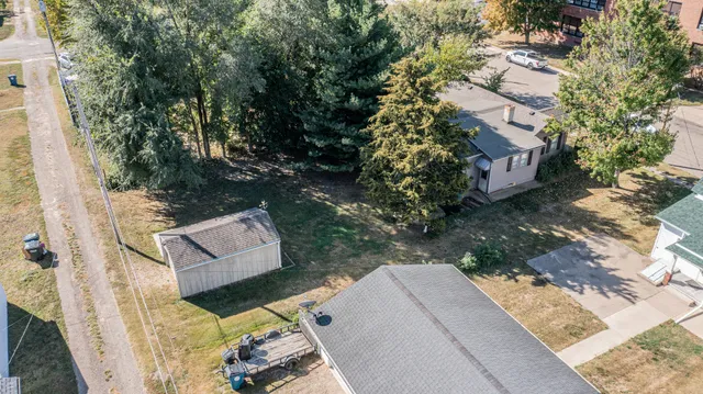 a view of backyard with outdoor seating and trees
