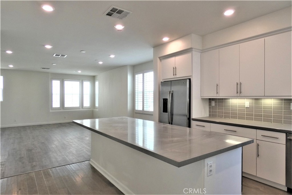 130 Acamar Irvine, CA 92618 - Photo 15 of 43 a kitchen with stainless steel appliances granite countertop a sink a stove and a refrigerator