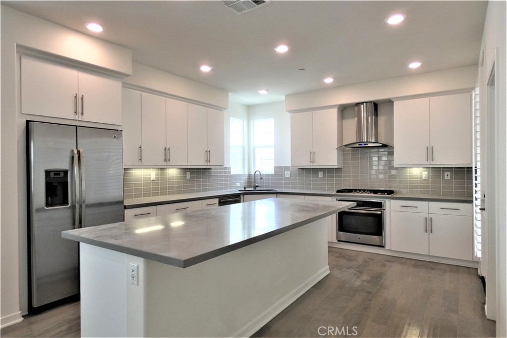 130 Acamar Irvine, CA 92618 - Photo 16 of 43 a large kitchen with stainless steel appliances granite countertop a stove a sink and a refrigerator
