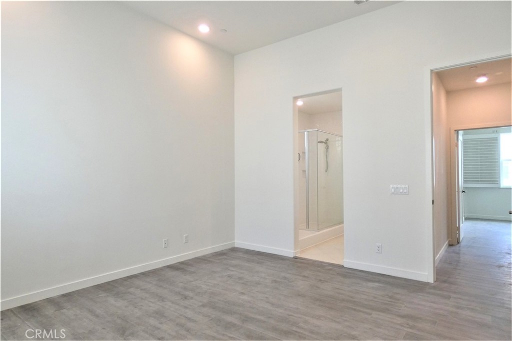 130 Acamar Irvine, CA 92618 - Photo 22 of 43 an empty room with wooden floor and mirror