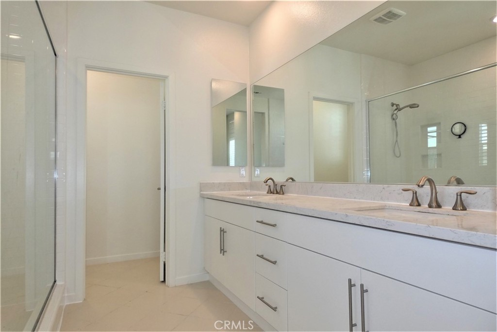 130 Acamar Irvine, CA 92618 - Photo 25 of 43 a bathroom with a granite countertop sink mirror and double
