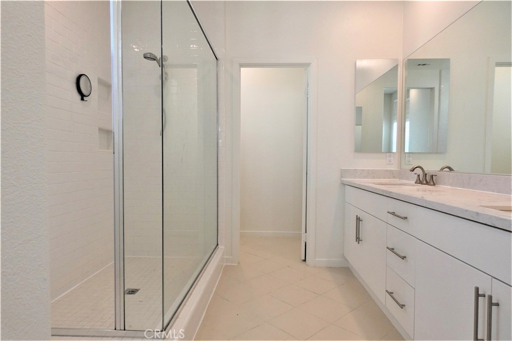130 Acamar Irvine, CA 92618 - Photo 26 of 43 a bathroom with a double vanity sink and mirror