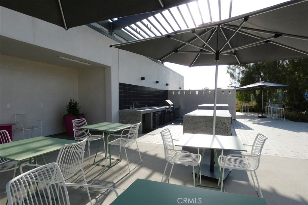 130 Acamar Irvine, CA 92618 - Photo 38 of 43 a view of a patio with table and chairs under an umbrella