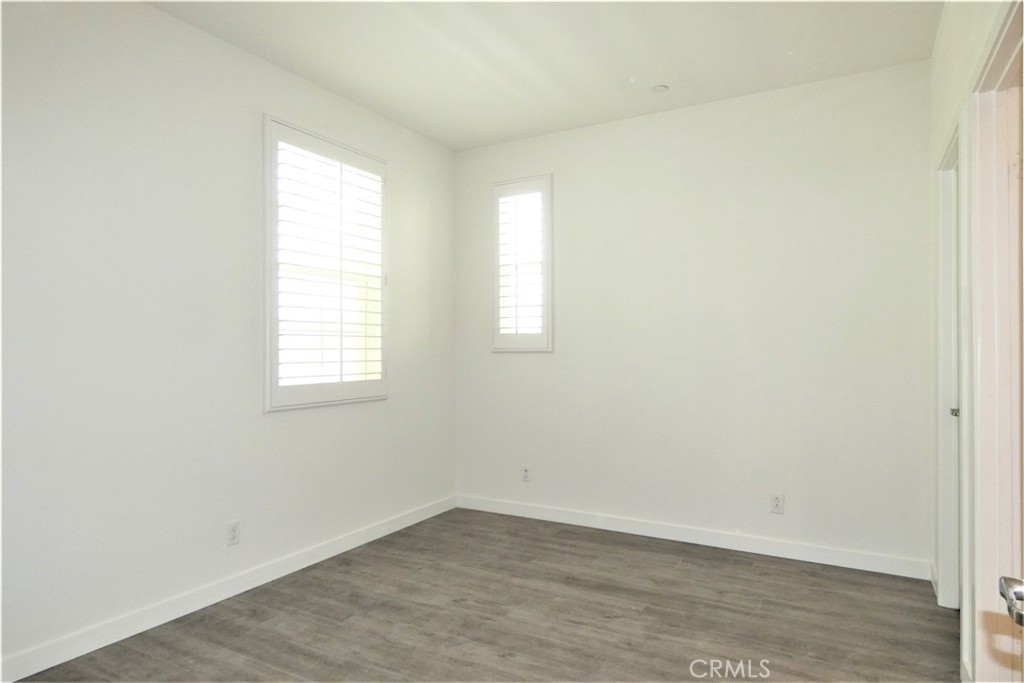 130 Acamar Irvine, CA 92618 - Photo 5 of 43 an empty room with wooden floor and windows