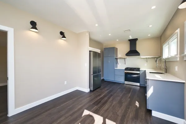 a kitchen with stainless steel appliances a refrigerator and a stove top oven