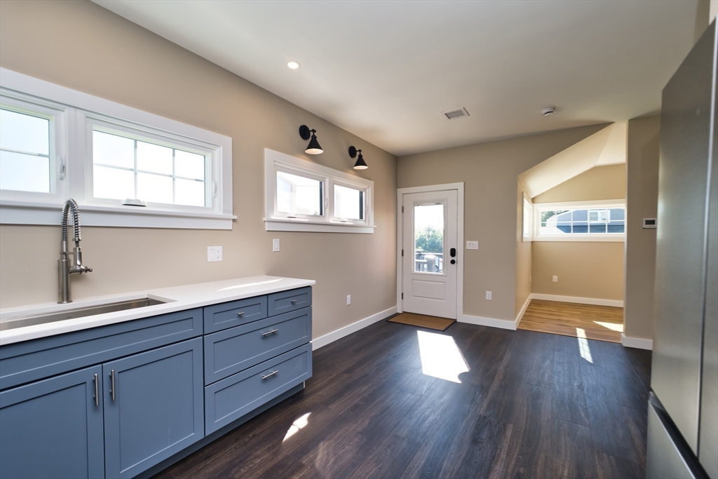 41 Point Street Fairhaven, MA 02719 - Photo 13 of 25 a hallway with wooden floors and cabinet