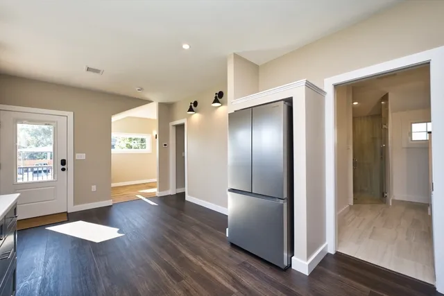 a view of empty room with wooden floor