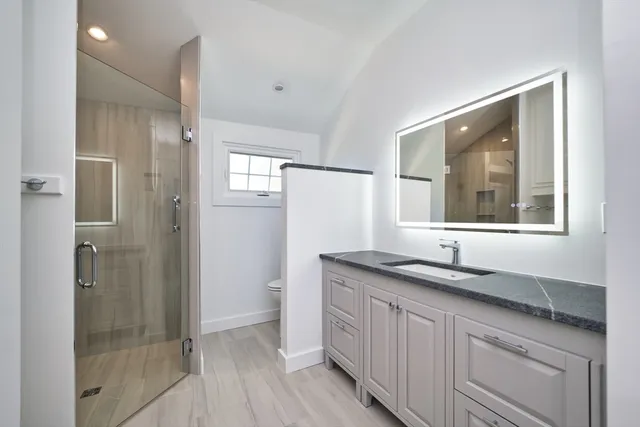 a bathroom with a granite countertop sink mirror and double