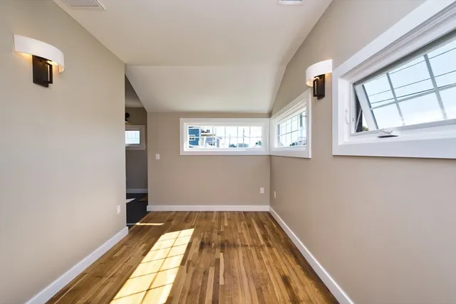 a view of a room with wooden floor and window