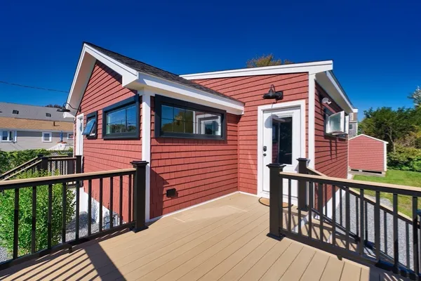 a view of a house with wooden deck