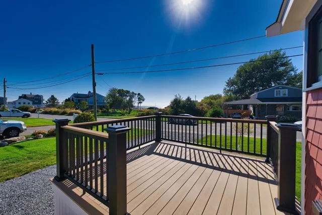 a view of balcony with wooden floor and outdoor seating