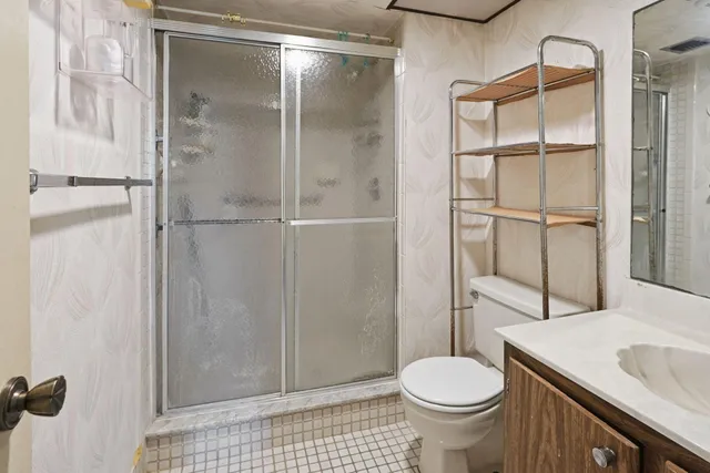 a bathroom with a sink toilet and shower