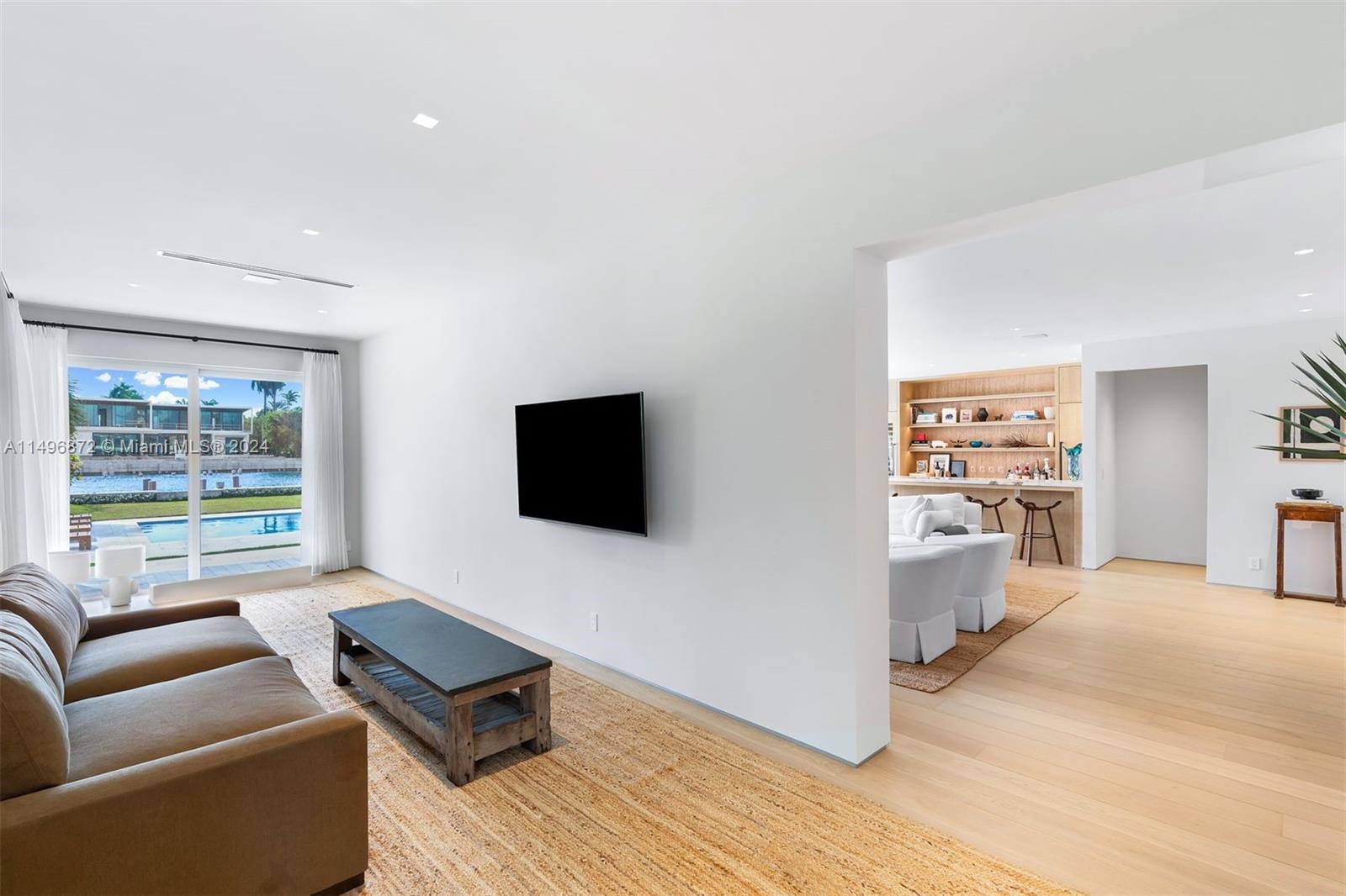 2770 Sunset Drive Miami Beach, FL 33140 - Photo 11 of 56 a living room with furniture and a flat screen tv