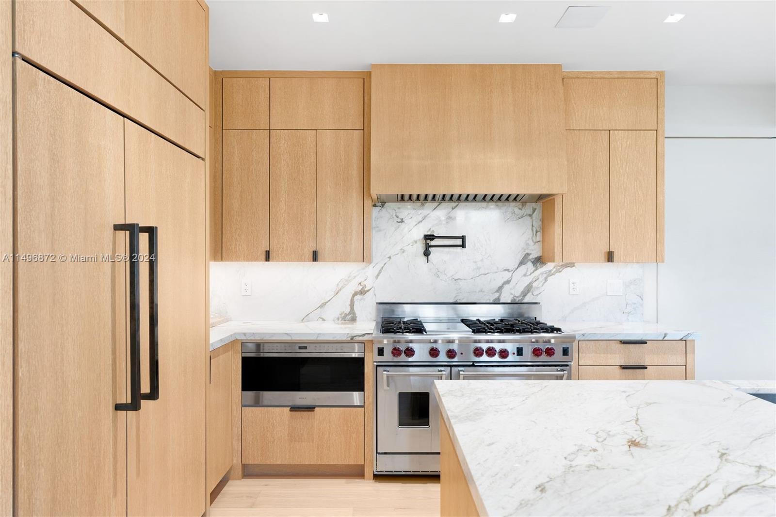 2770 Sunset Drive Miami Beach, FL 33140 - Photo 14 of 56 a kitchen with stainless steel appliances granite countertop a stove a sink and a refrigerator