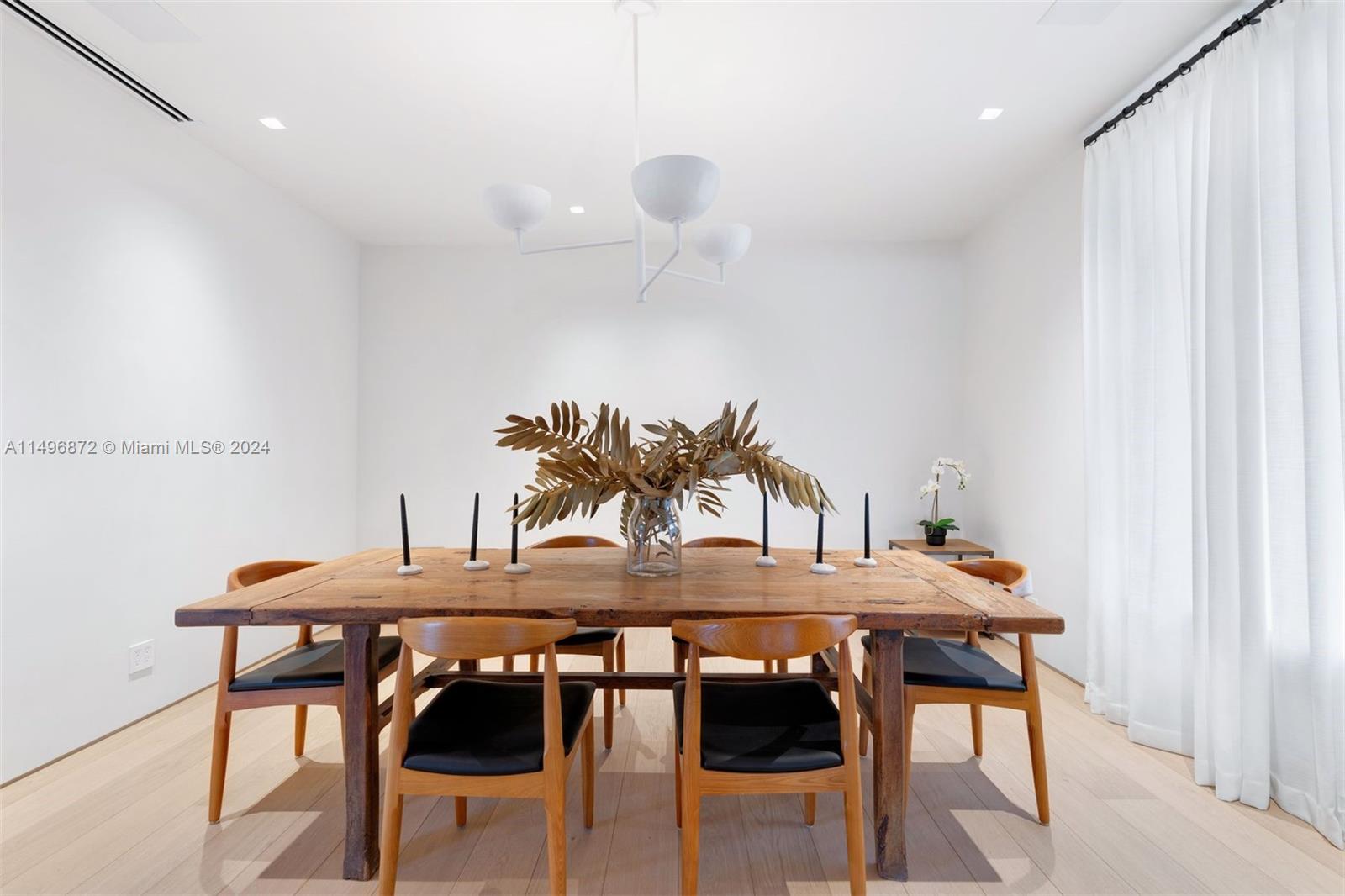 2770 Sunset Drive Miami Beach, FL 33140 - Photo 16 of 56 a view of a dining room with furniture and wooden floor