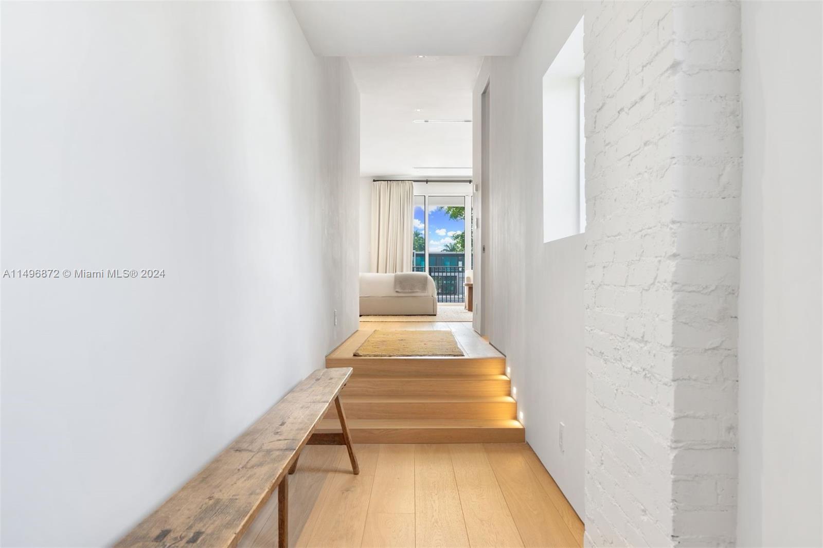 2770 Sunset Drive Miami Beach, FL 33140 - Photo 18 of 56 a hallway with a white couches and painted walls