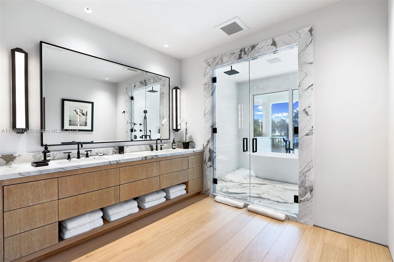 2770 Sunset Drive Miami Beach, FL 33140 - Photo 25 of 56 a spacious bathroom with double vanity and a mirror