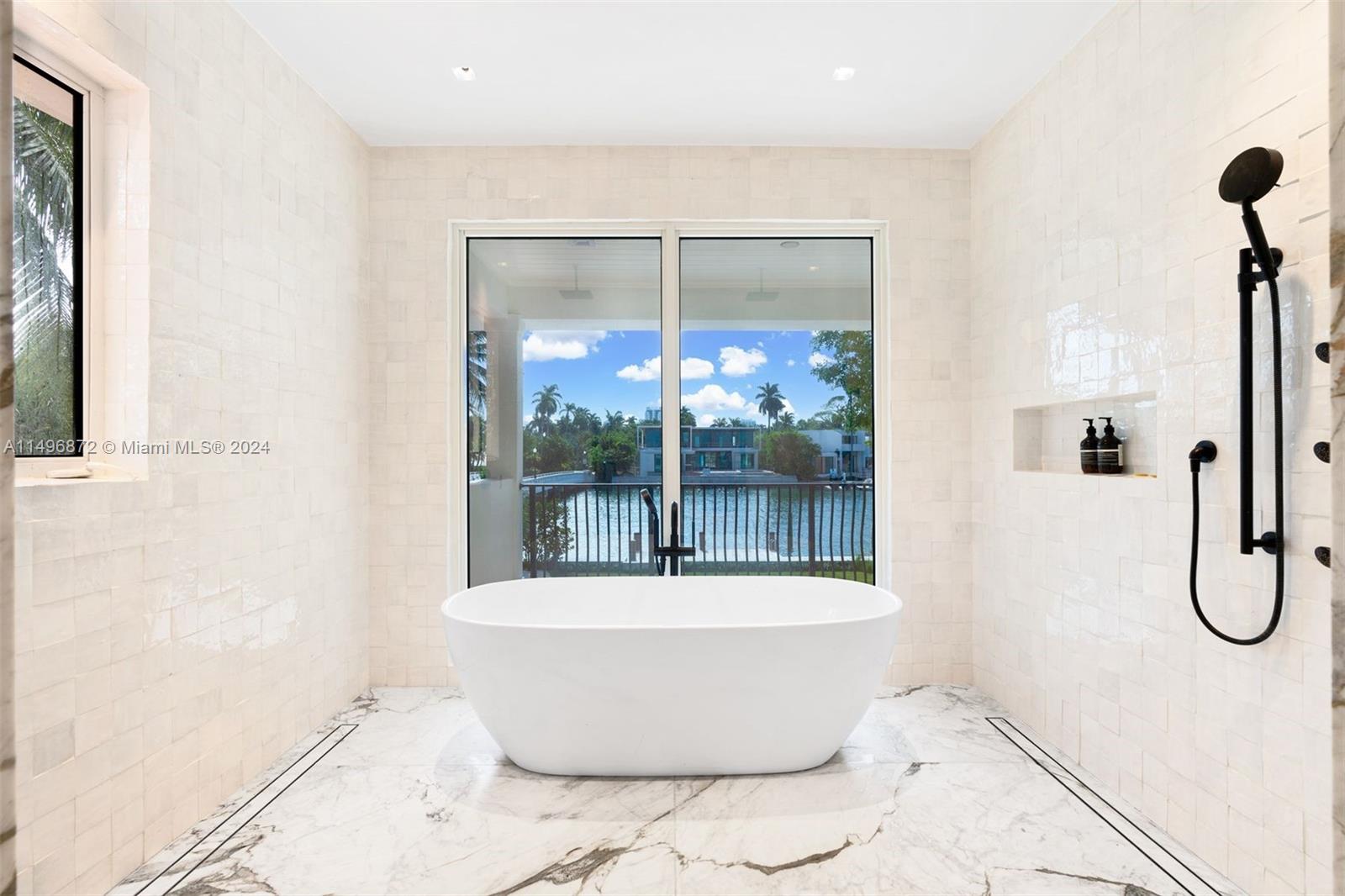 2770 Sunset Drive Miami Beach, FL 33140 - Photo 26 of 56 a white bath tub sitting next to a shower