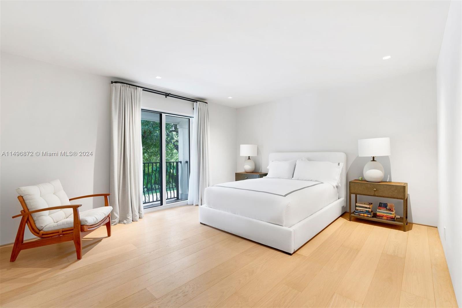 2770 Sunset Drive Miami Beach, FL 33140 - Photo 27 of 56 a bedroom with a bed chair and a large window