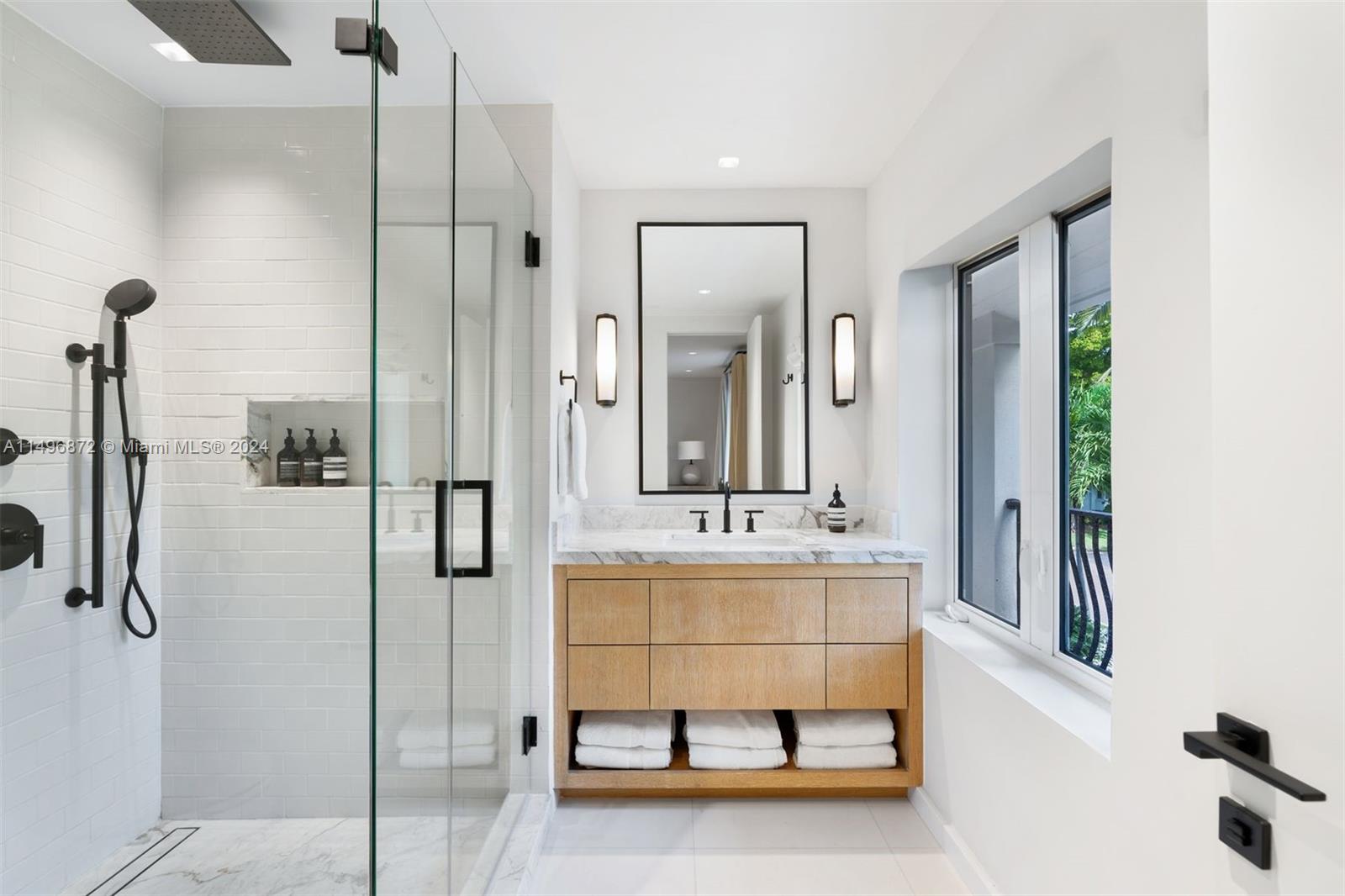 2770 Sunset Drive Miami Beach, FL 33140 - Photo 28 of 56 a bathroom with a tub sink and mirror