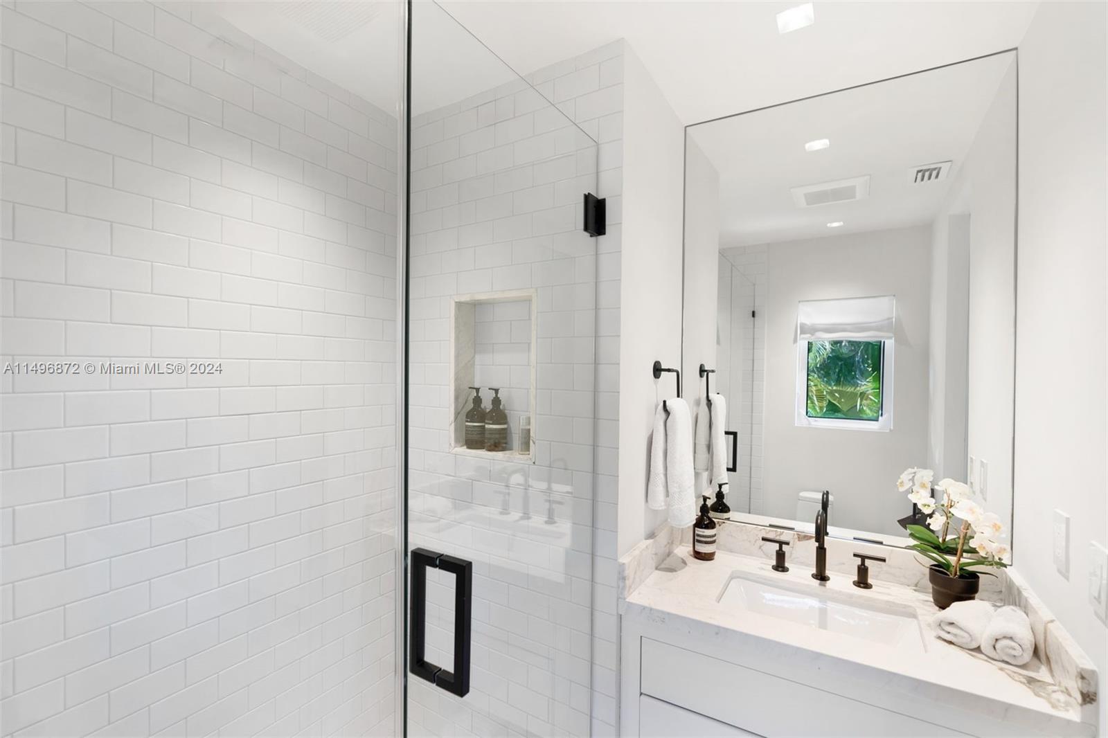 2770 Sunset Drive Miami Beach, FL 33140 - Photo 33 of 56 a bathroom with a sink and a mirror