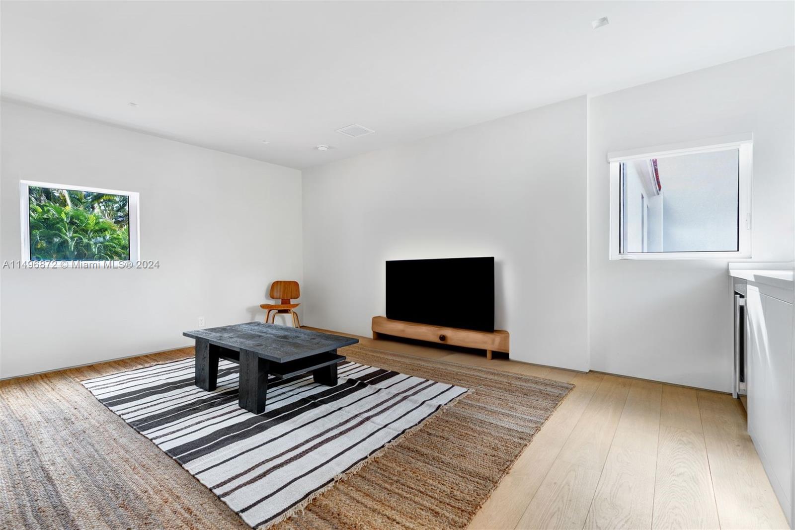 2770 Sunset Drive Miami Beach, FL 33140 - Photo 34 of 56 a living room with furniture and a flat screen tv