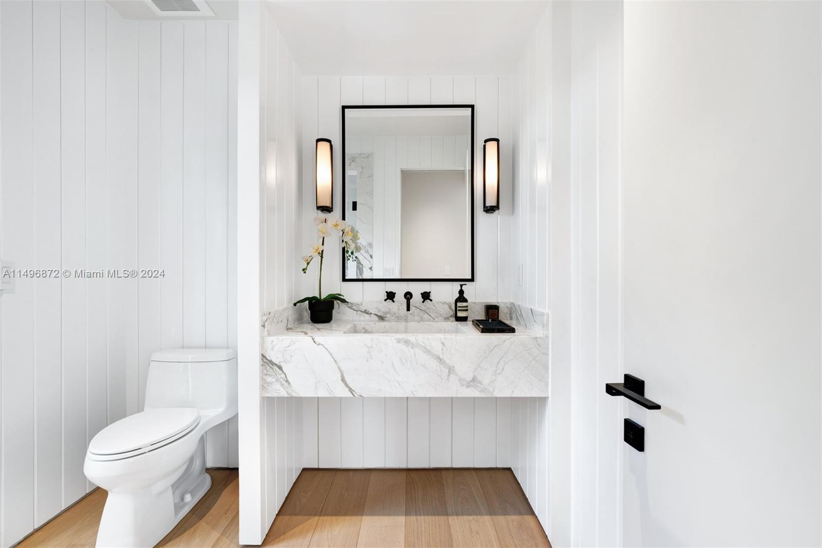 2770 Sunset Drive Miami Beach, FL 33140 - Photo 35 of 56 a bathroom with a sink and a mirror