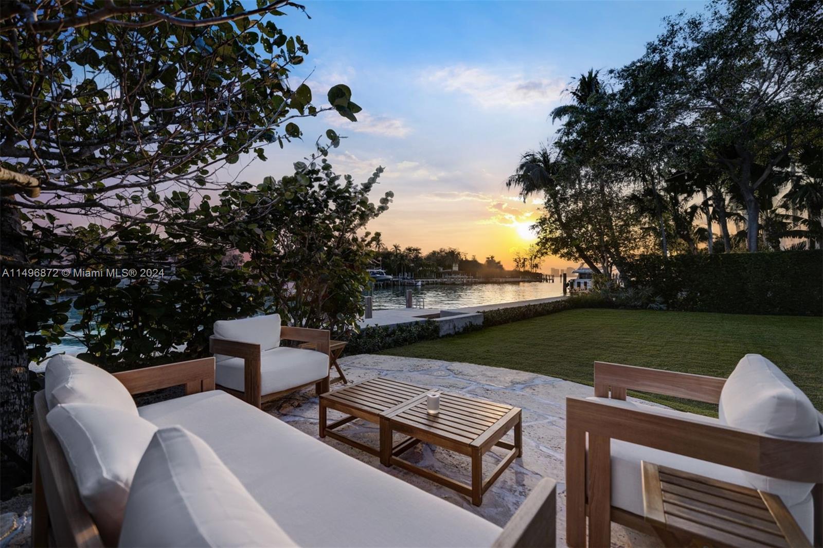 2770 Sunset Drive Miami Beach, FL 33140 - Photo 46 of 56 a view of a patio with lawn chairs next to a yard